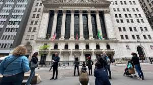 A group of people gathered outside the New York Stock Exchange building.